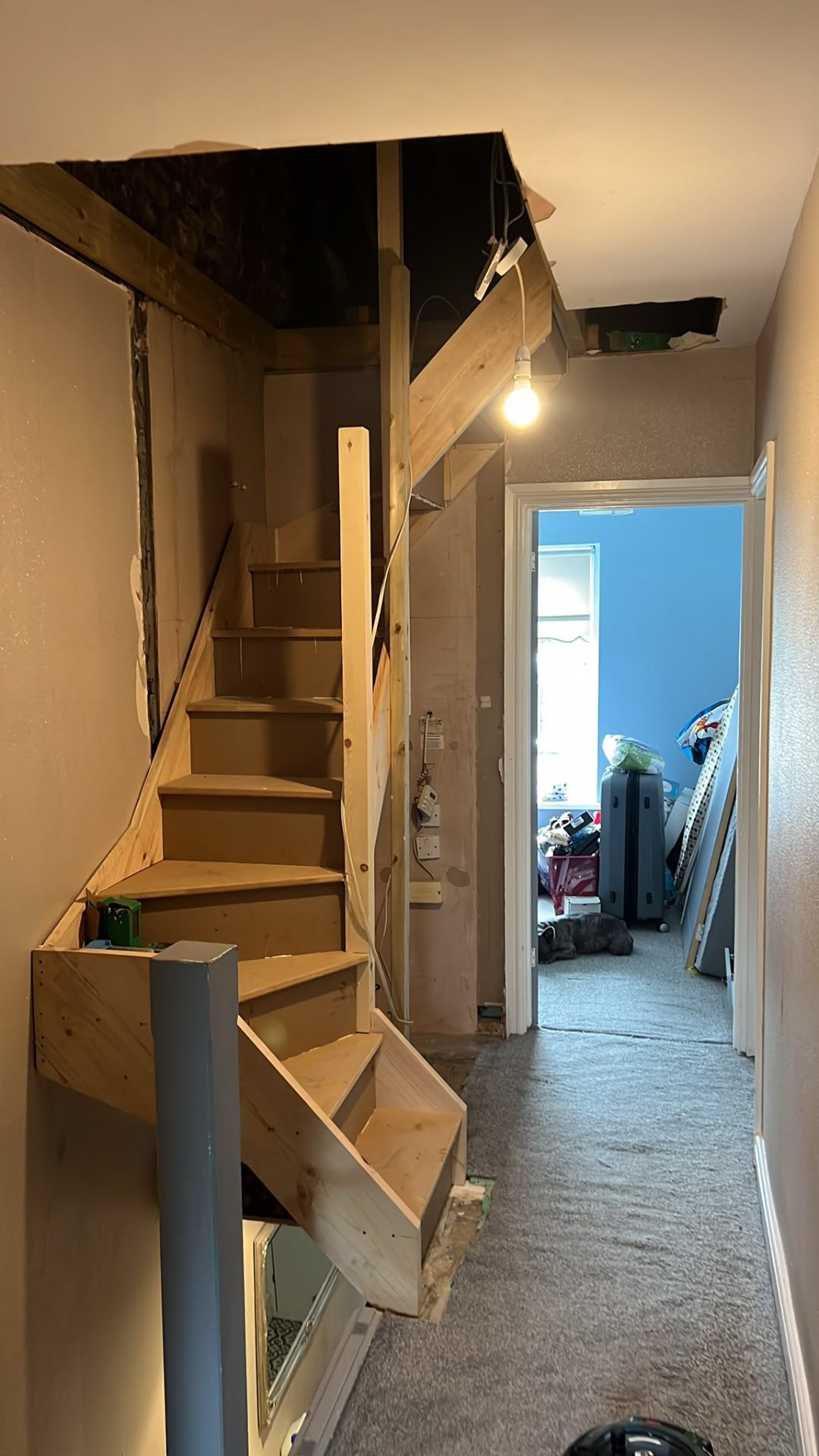 New timber staircase installation leading to a loft conversion within a residential property.